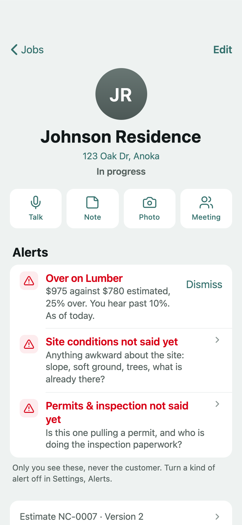 A running job in the app: the customer's name and address, its stage in words, In progress, and its alerts: over on lumber, 25% past its estimate, with Dismiss, and two things the estimate still needs said; below them, its estimate, numbered under the business's initials.